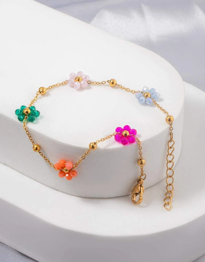 BRACELET À FLEURS EN MÉTAL DORÉ